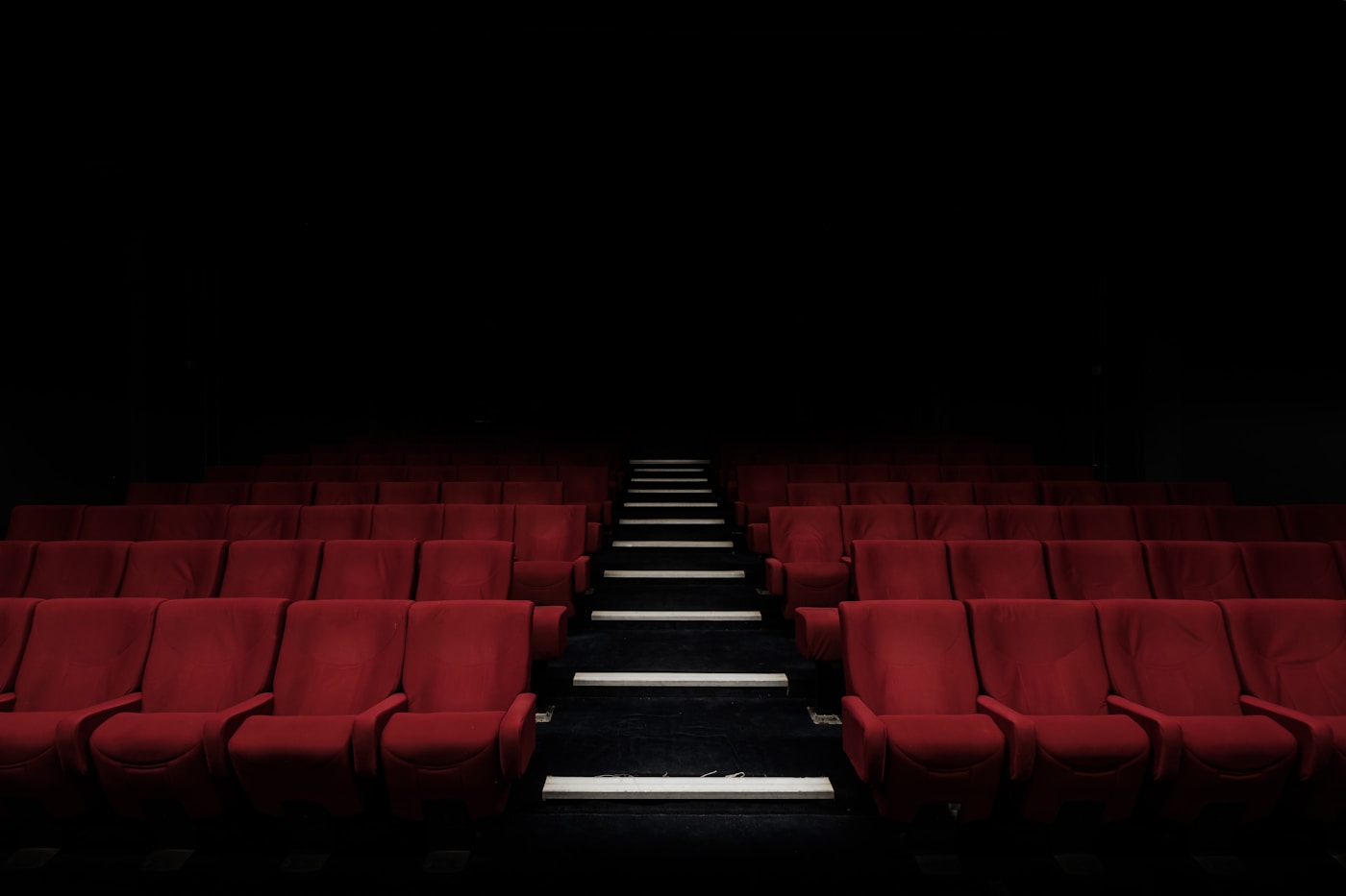 Empty cinema with rows of red seats